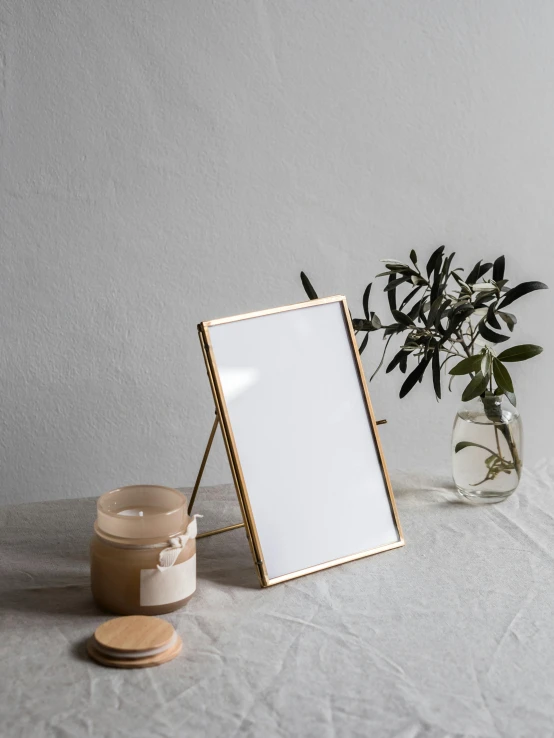 a picture frame sitting on top of a table, by Rebecca Horn, gold metal, high quality product photo, side portrait, natural morning light