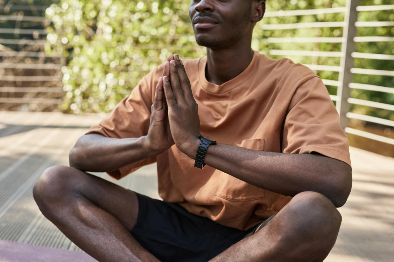 a man sitting in the middle of a yoga pose, wears a watch, emmanuel shiru, black fine lines on warm brown, warm weather