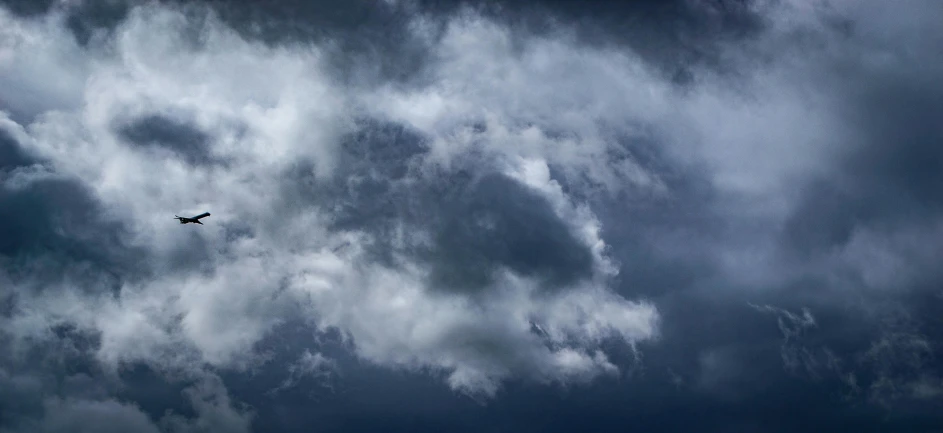 a large jetliner flying through a cloudy sky, by Jan Rustem, pexels contest winner, conceptual art, cumulus, close-up photograph, panorama view of the sky, below only cloud dark void