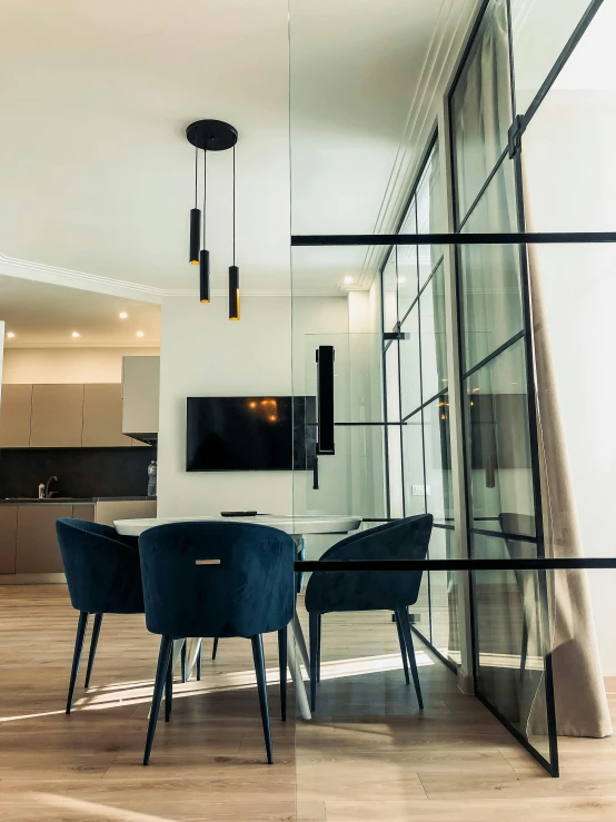 a room that has a table and chairs in it, by Adam Marczyński, unsplash, modernism, luxury condo interior, steel window mullions, warsaw, high transparency