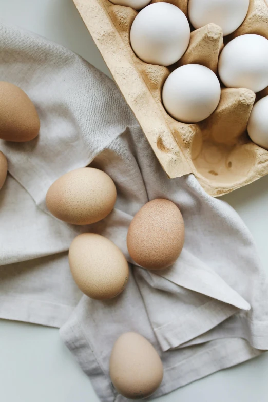 a tray of eggs sitting on top of a table, by Carey Morris, trending on unsplash, linen, “organic, promo image, beige
