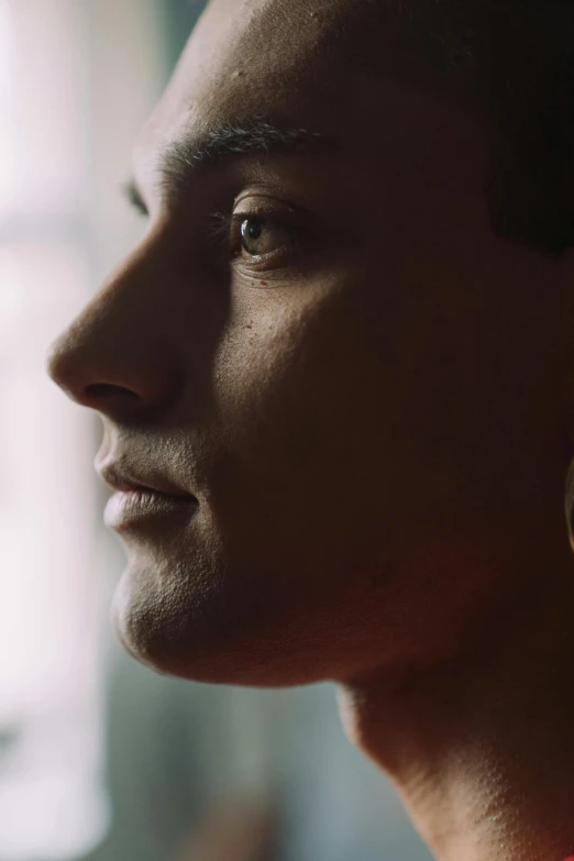 a close up of a person looking out a window, defined jawline, cinematic shot ar 9:16 -n 6 -g, ben shapiro, anton fadeev 8 k