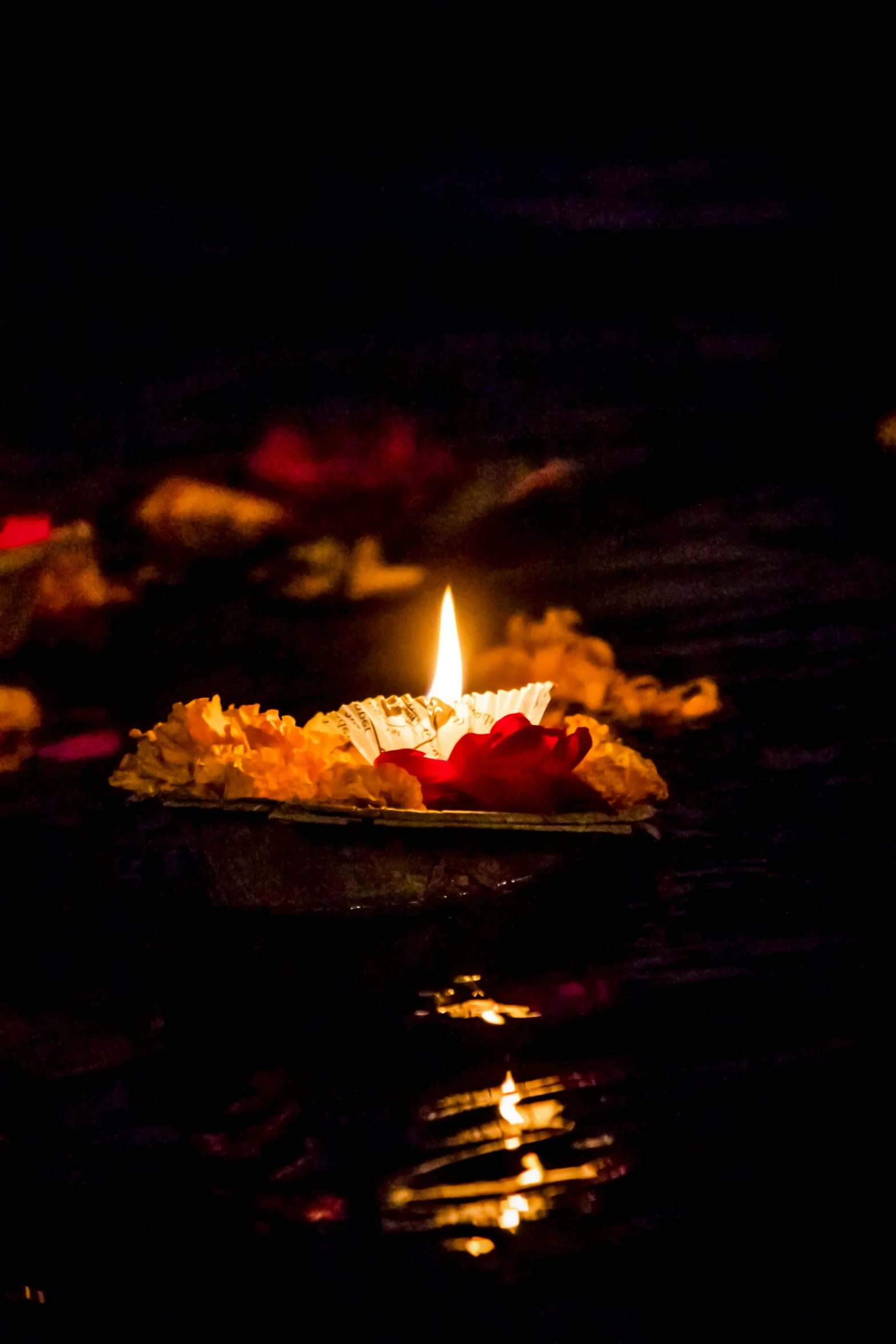 a lit candle floating on top of a body of water, nepal, slide show, lights with bloom, uploaded