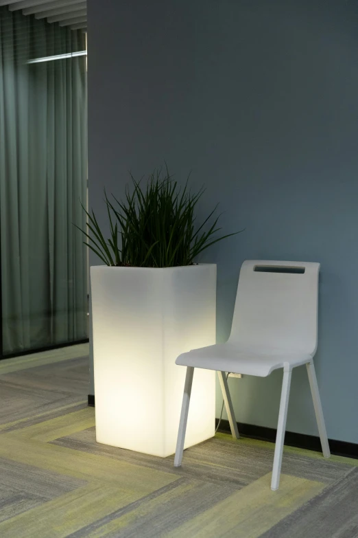 a white chair sitting next to a tall planter, light and space, fluorescent led, nadir lighting, detail shot, square