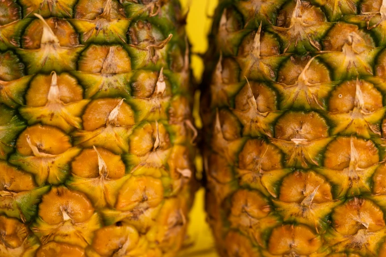 two pineapples sitting next to each other on a table, by Adam Marczyński, pexels, fan favorite, bottom body close up, banana color, hyperdetailed