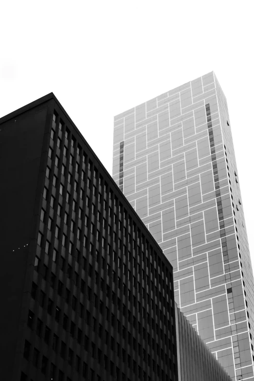 a black and white photo of a tall building, inspired by David Chipperfield, unsplash, minneapolis, square shapes, two towers, contrasting colors