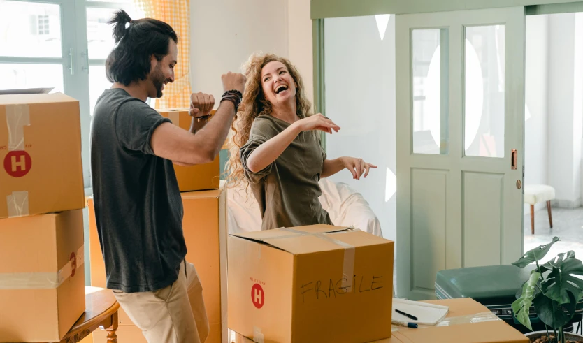 a man and a woman standing in a room with boxes, pexels contest winner, happening, smiling and dancing, avatar image, australian, raphael lecoste