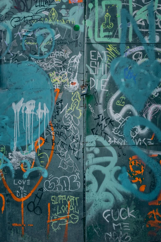 a wall covered in lots of graffiti next to a fire hydrant, trending on pexels, black and teal paper, blueberry and orange and teal, 2 0 5 6, slate