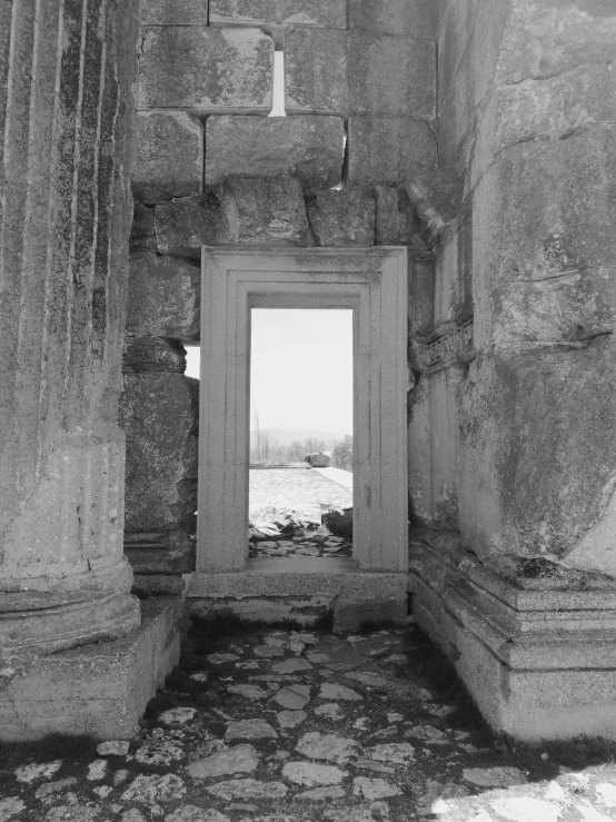 a black and white photo of a doorway in a stone building, white stone temple ruins, 1981 photograph, 1 9 8 5 photograph, nuri iyem