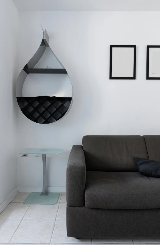 a couch sitting in a living room next to a table, inspired by Willem Claeszoon Heda, pexels contest winner, minimalism, an upside down urinal, hanging cables, black lacquer, shelves