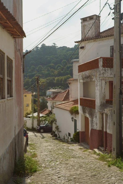 a person riding a horse down a cobblestone street, inspired by Almada Negreiros, hillside, slide show, red roofs, exterior