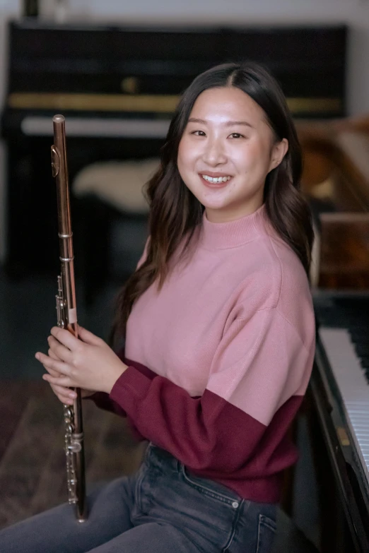 a woman sitting in front of a piano holding a flute, inspired by Song Xu, headshot, pokimane, music phd, wholesome