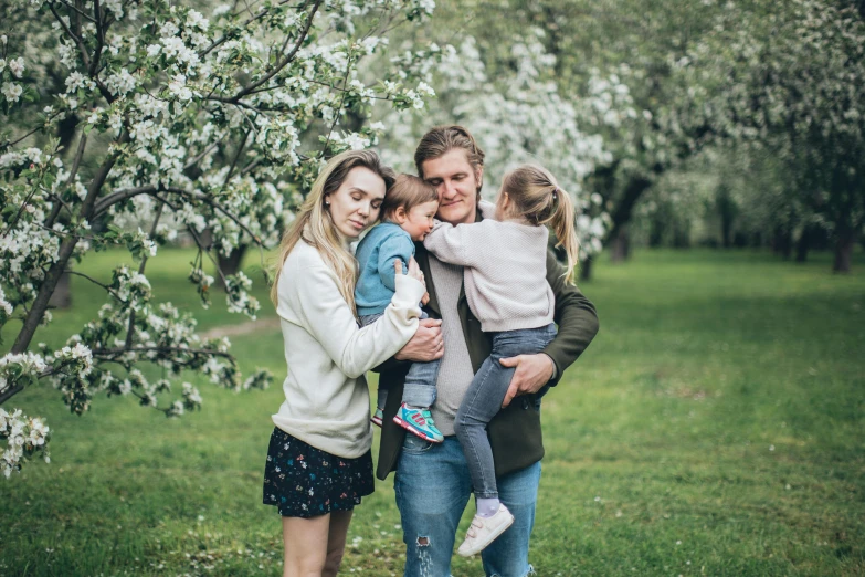 a family posing for a picture in an apple orchard, a portrait, by Emma Andijewska, pexels, figuration libre, under sakura tree, thumbnail, street photo, profile picture 1024px