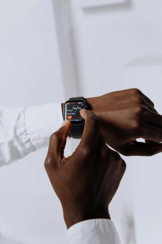 a close up of a person holding an apple watch, by Carey Morris, hypermodernism, man is with black skin, black and orange, on grey background, thumbnail