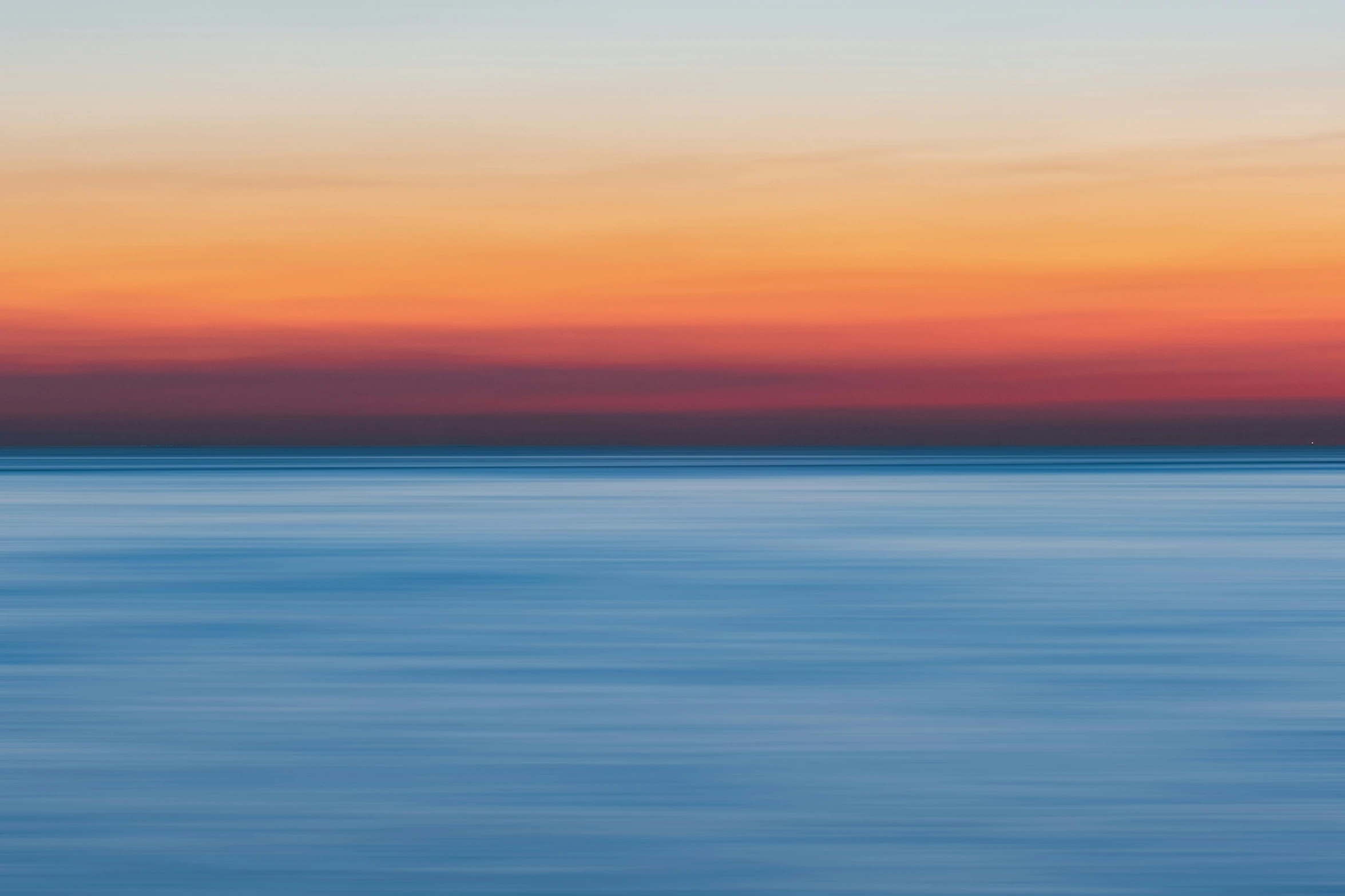 a large body of water with a sunset in the background, inspired by Jan Rustem, minimalism, fine color lines, zoomed out photography, color ( sony a 7 r iv, impressionist