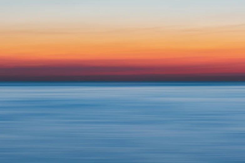 a large body of water with a sunset in the background, inspired by Jan Rustem, minimalism, fine color lines, zoomed out photography, color ( sony a 7 r iv, impressionist