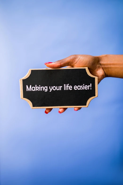 a person holding a sign that says making your life easier, unsplash, profile image, album cover, claymation style, product shot