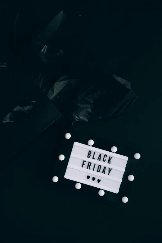 a black friday sign sitting on top of a table, pexels contest winner, vantablack, color picture, holiday, instagram picture