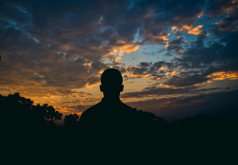 a silhouette of a man standing in front of a sunset, profile image, instagram picture, sunset with cloudy skies, profile pic