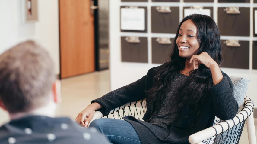 a woman sitting in a chair talking to a man, profile image, sharp focus », black female, professional image