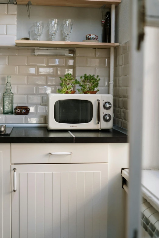 a white microwave sitting on top of a kitchen counter, unsplash, basil, old tv, polish mansion kitchen, square