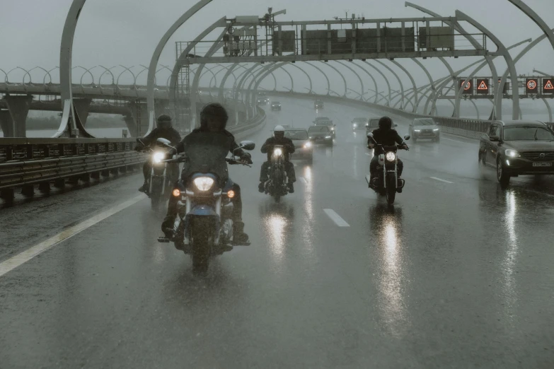 a group of people riding on the back of motorcycles, by Jens Søndergaard, pexels contest winner, conceptual art, rain and haze, overpass, cinematic front lightning, film still from the movie