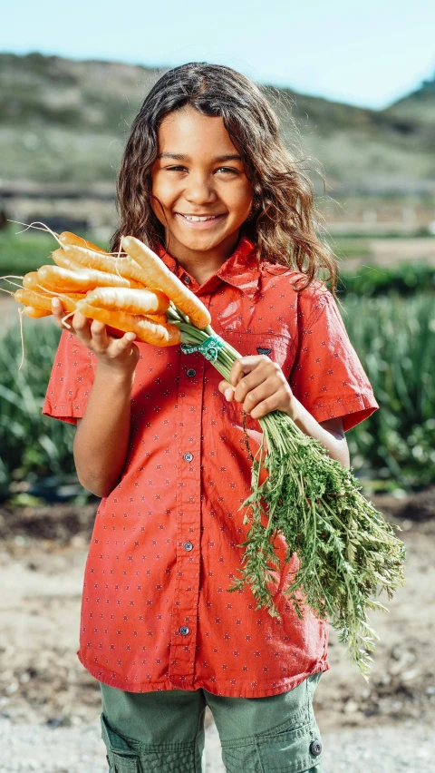 a young girl holding a bunch of carrots, by Elizabeth Durack, unsplash, aboriginal, museum quality photo, wearing an orange t-shirt, hydroponic farms