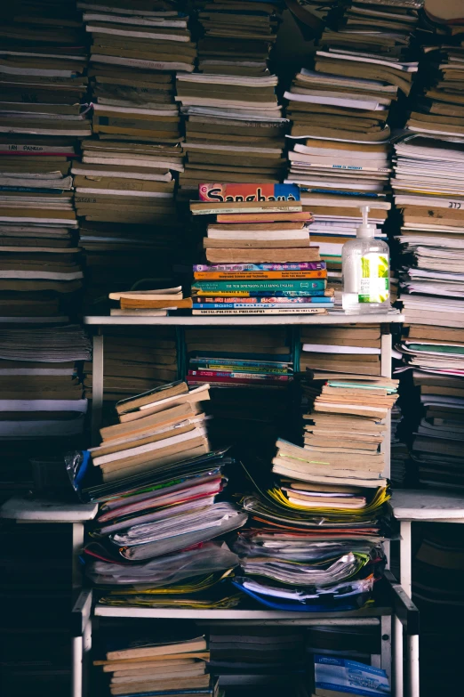 a stack of books sitting on top of a metal shelf, unsplash, maximalism, piles of trash and junk, scientific research, photo of a classroom, profile picture