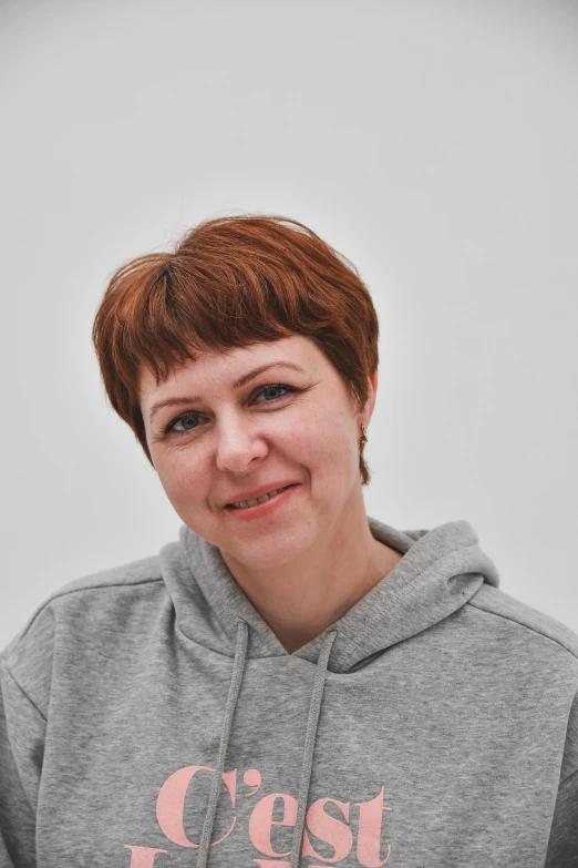 a close up of a person wearing a hoodie, by Grytė Pintukaitė, with short hair, on clear background, russian academic, indoor picture