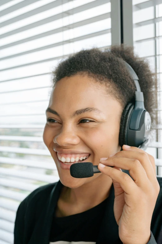 a close up of a person wearing a headset, pexels contest winner, welcoming grin, maintenance, black, npc talking