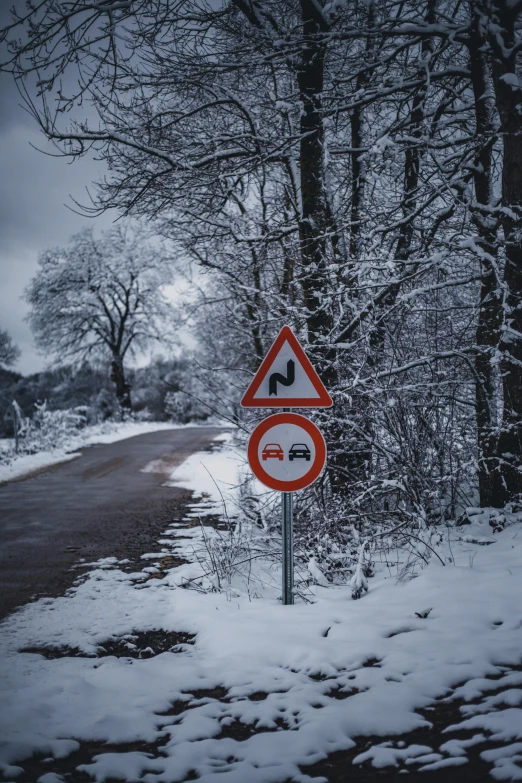 a red and white sign sitting on the side of a road, by Adam Marczyński, pexels contest winner, snow weather, lower saxony, thumbnail, multiple stories