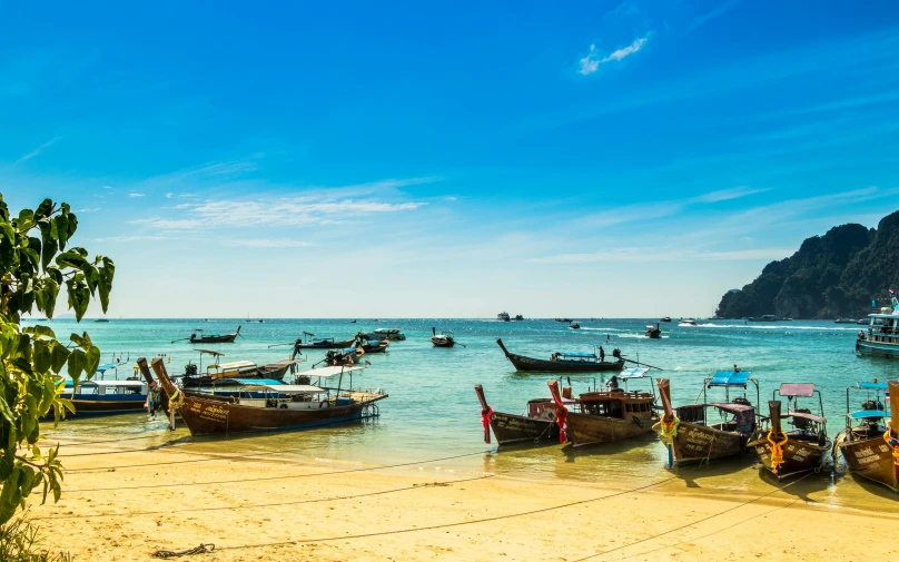 a group of boats sitting on top of a sandy beach, thai, avatar image, high-resolution photo