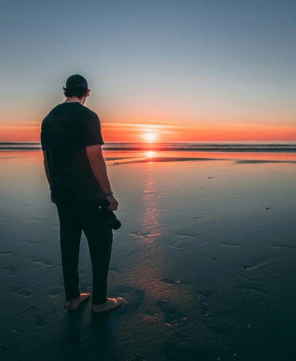 a man standing on a beach at sunset, unsplash contest winner, full body photo, gazing off into the horizon, photo of a man, casually dressed