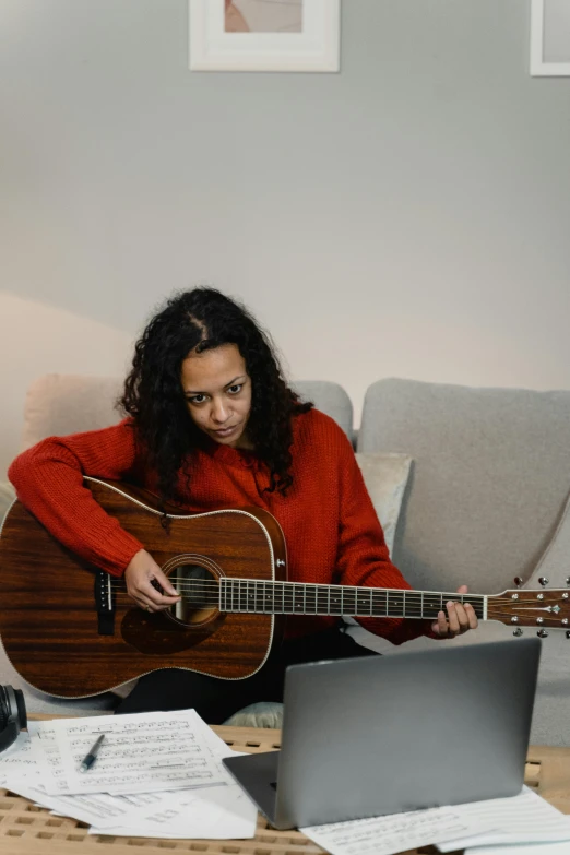 a woman sitting on a couch playing a guitar, art & language, in front of a computer, promo image, multiple stories, riyahd cassiem