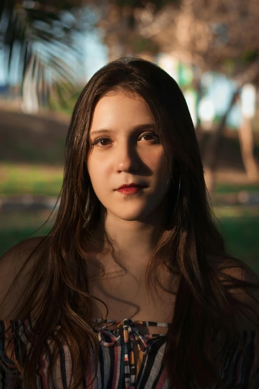 a woman standing in a park with a frisbee in her hand, an album cover, inspired by Elsa Bleda, unsplash, renaissance, brown hair and large eyes, headshot profile picture, beautiful taissa farmiga, color photograph portrait 4k