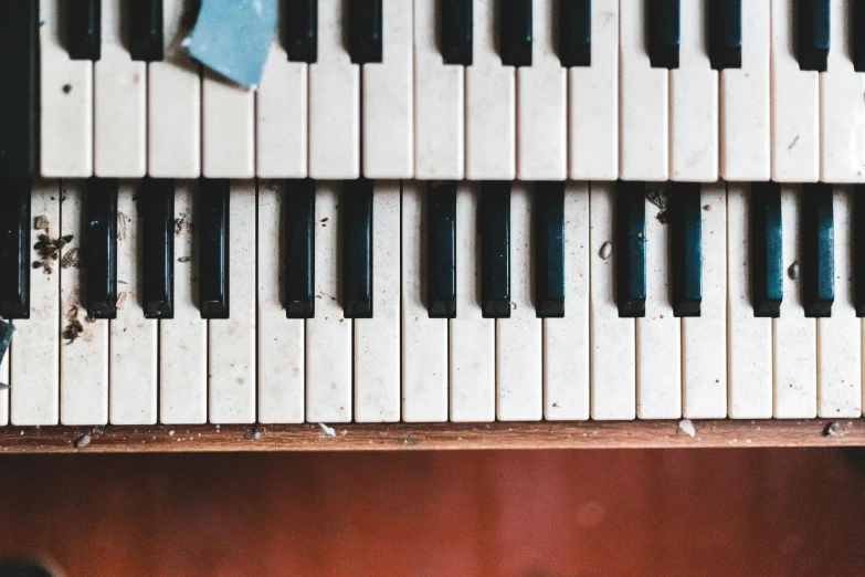 a close up of the keys of a piano, an album cover, inspired by Bryan Organ, unsplash, abandoned vibes, background image, flat lay, frank moth