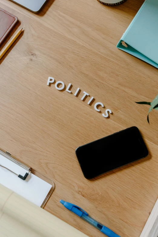 a wooden table topped with lots of office supplies, a cartoon, trending on pexels, modernism, presidental elections candidates, photo on iphone, words, thumbnail