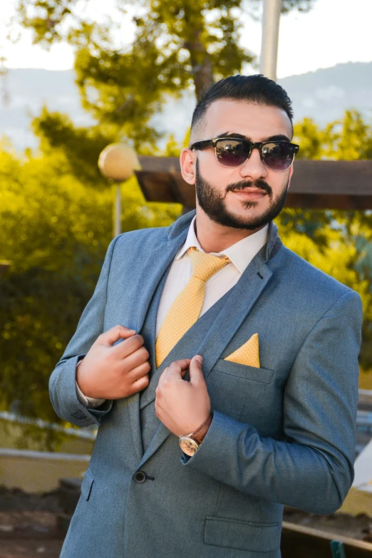 a man in a gray suit and yellow tie, pexels contest winner, assyrian, at a fashion shoot, facebook post, arab