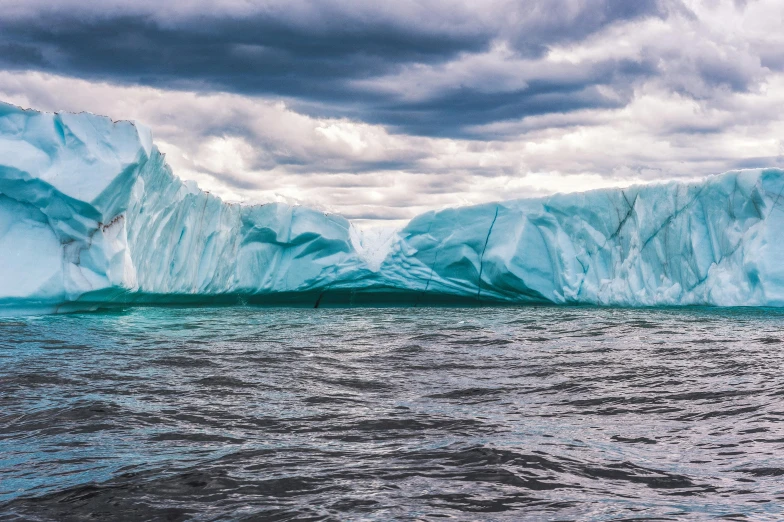 a large iceberg floating on top of a body of water, by Jesper Knudsen, pexels contest winner, fan favorite, wall of water either side, 2 0 2 2 photo, ultrawide landscape