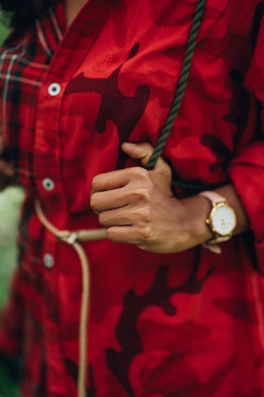 a woman in a red camo shirt holding an umbrella, trending on unsplash, renaissance, holding gold watch, wearing a red lumberjack shirt, detail shot, hands crossed