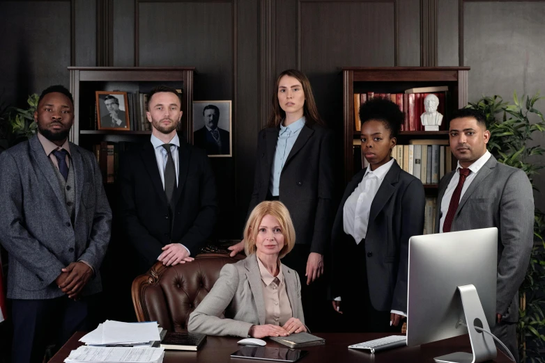 a group of business people posing for a picture, a portrait, by Carey Morris, pexels contest winner, renaissance, female lawyer, on desk, serious, promotional image