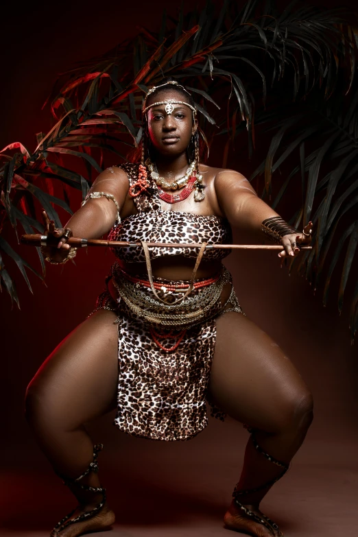 a woman in a costume holding a sword, an album cover, by Ingrida Kadaka, pexels contest winner, afrofuturism, alluring plus sized model, queen of the jungle, loin cloth, chocolate