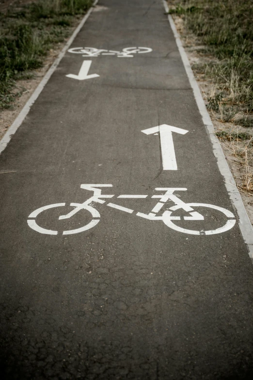 a bike path with the number one painted on it, unsplash, with two arrows, paul barson, symbols, blank