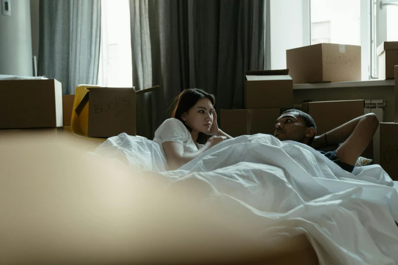 a woman laying in a bed next to a man, pexels contest winner, cardboard, movie clip, leaving a room, promotional image