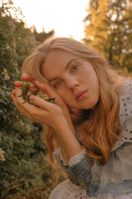 a close up of a person holding a flower, a picture, by Eva Frankfurther, trending on pexels, renaissance, annasophia robb as link, sitting on a leaf, sydney sweeney, medium format. soft light