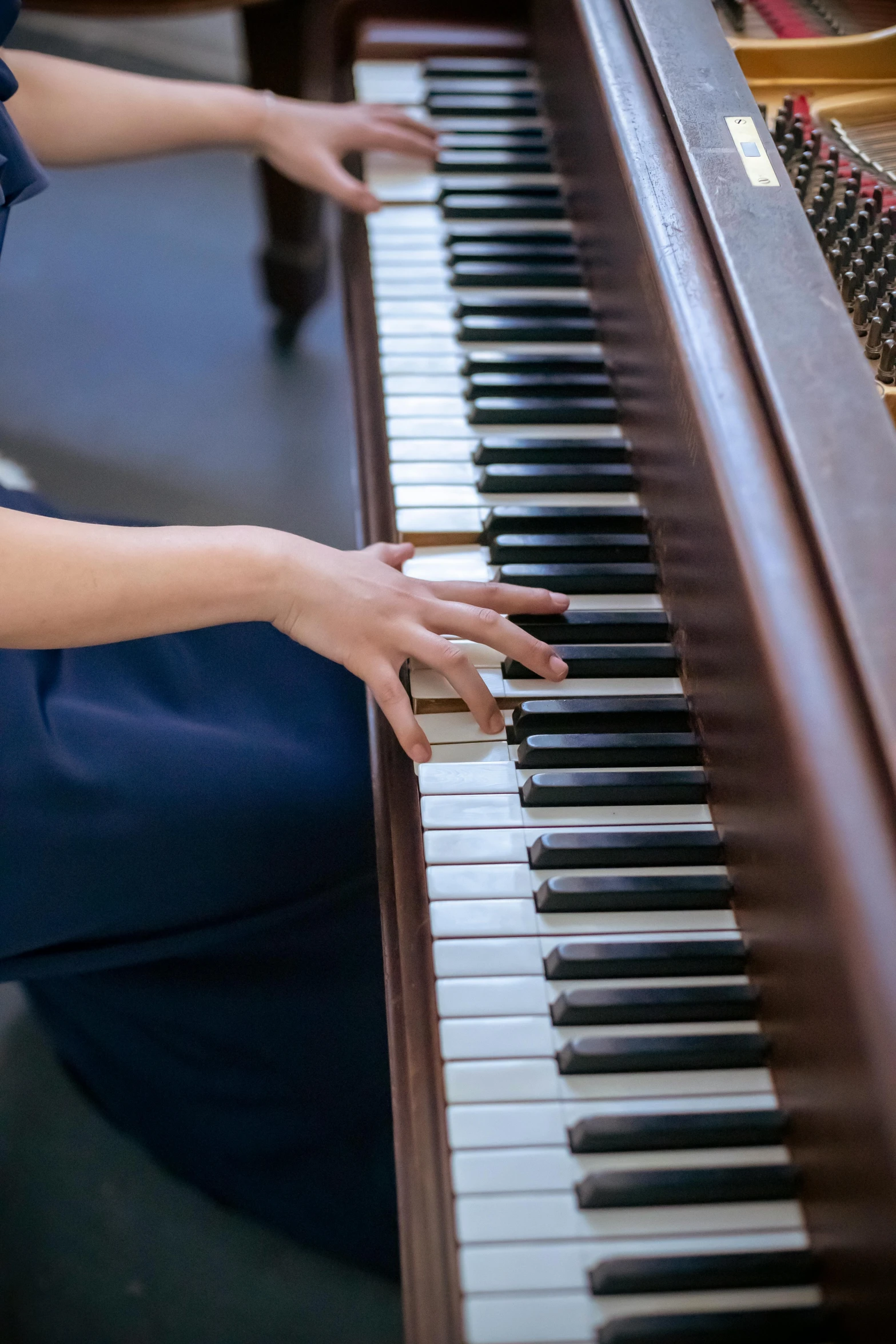 a woman in a blue dress playing a piano, by David Simpson, trending on unsplash, low detail, brown, wenjun lin, colour photograph