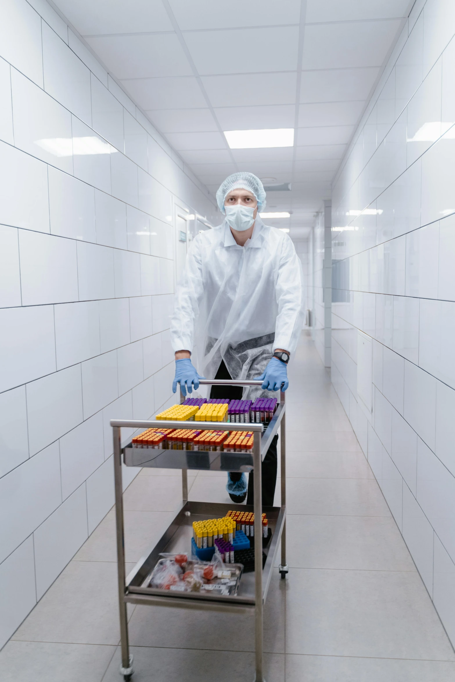 a man that is standing in a room with a cart, by Julia Pishtar, shutterstock, pathology sample test tubes, instagram photo, manufacturing, candy treatments