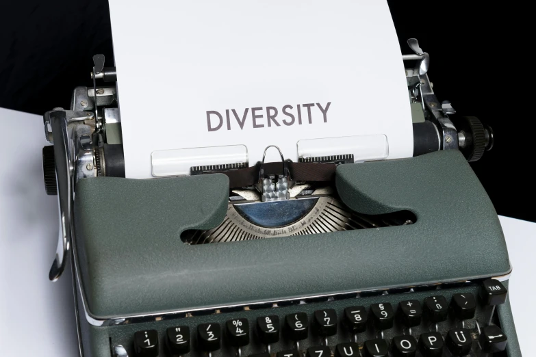 a typewriter with a piece of paper on top of it, by Carey Morris, unsplash, private press, mix of ethnicities and genders, ai biodiversity, gradient black to silver, diverse costumes