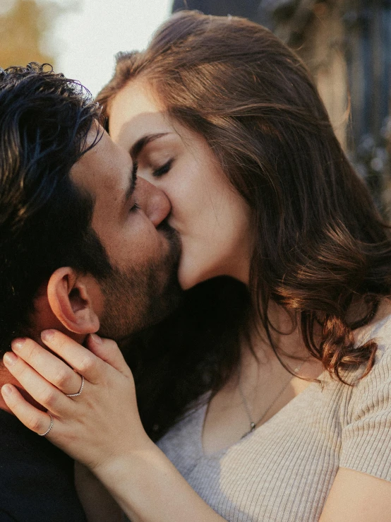 a man kissing a woman on the cheek, pexels contest winner, beard stubble, square masculine jaw, brunettes, hands pressed together in bow