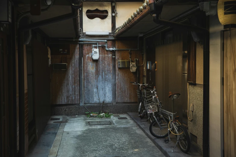 a couple of bikes parked inside of a building, a picture, unsplash contest winner, shin hanga, feudal japanese setting, alley, closed limbo room, nostalgic 8k